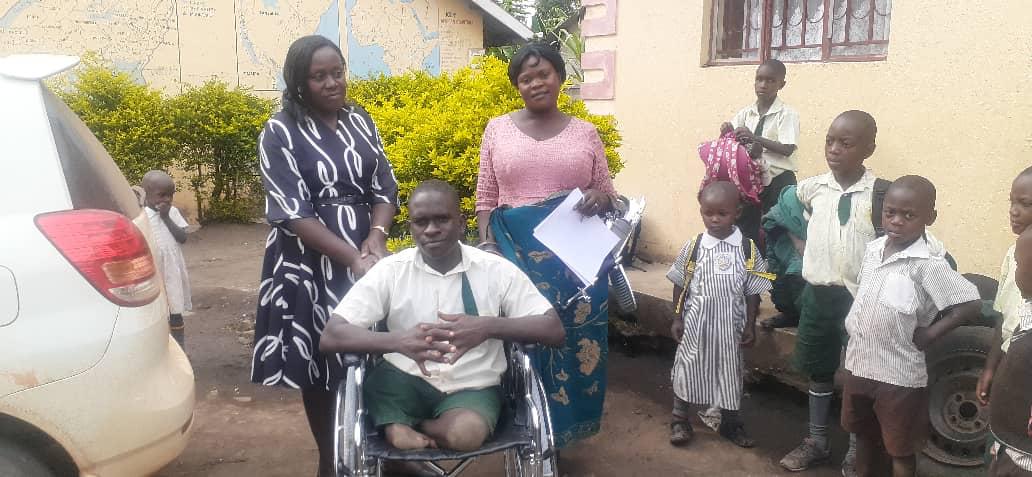 A wheelchair user supported by community members